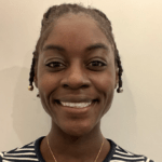 Surge Scholar Dr. Bridget Ochuko smiles for a headshot in front of a plain, beige wall. Her hair is pulled back and she's wearing a black and white-striped shirt.