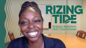Brittany Ballentine smiling while on a virtual phone call. Next to her, green text reads "Rizing Tide, Brittany Ballentine, 2022 Crest Scholar"