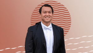 Professional portrait of physical therapist Jonathan Lee in front of an abstract orange background