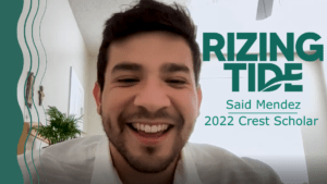 Said Mendez smiling while on a virtual phone call. Next to him, green text reads "Rizing Tide, Said Mendez, 2022 Crest Scholar."