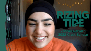 Still of Zahraa Darwich smiling while on a virtual phone call. Next to her, green text reads "Rizing Tide Zahraa Darwich 2022 Crest Scholar"